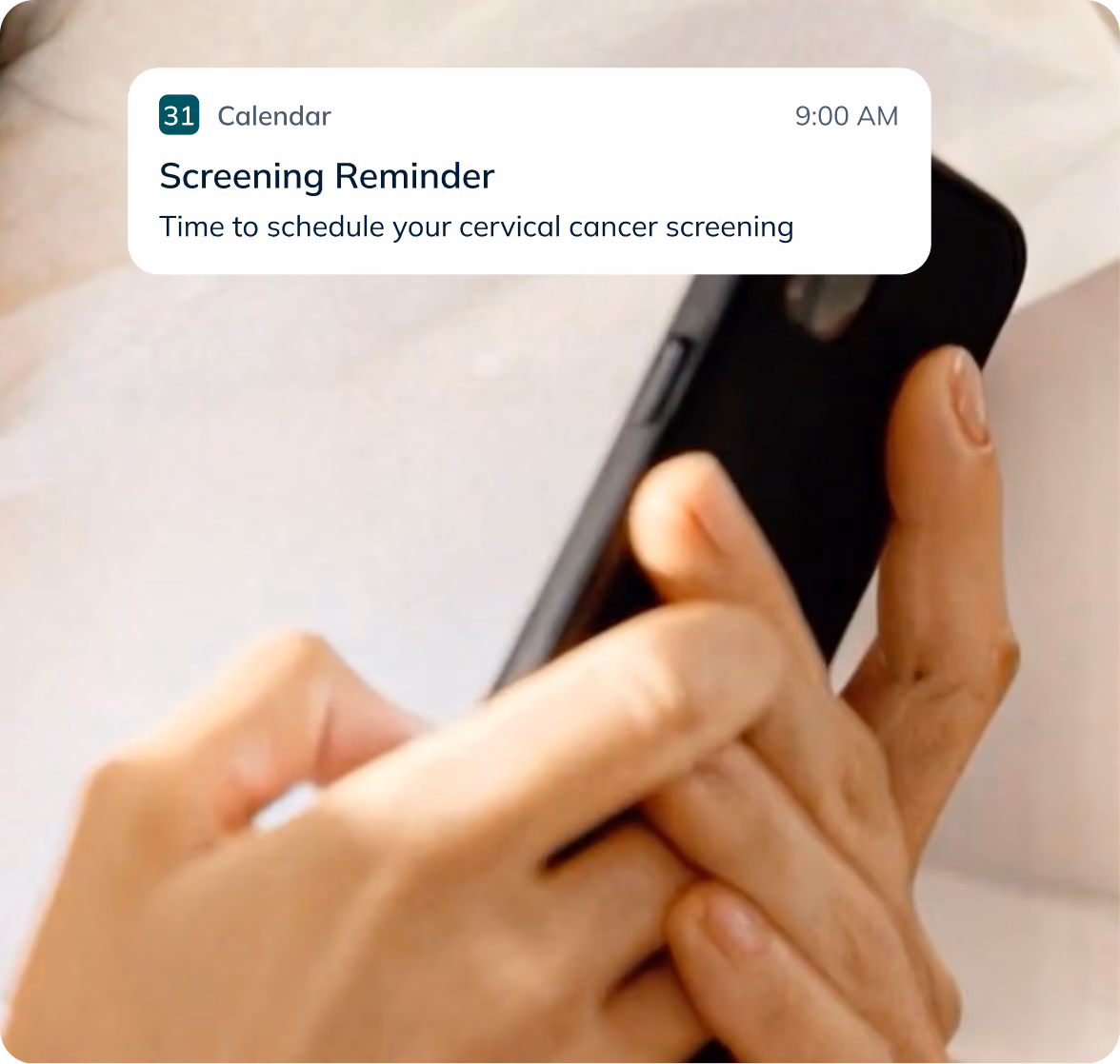 Hands typing on a phone in bed